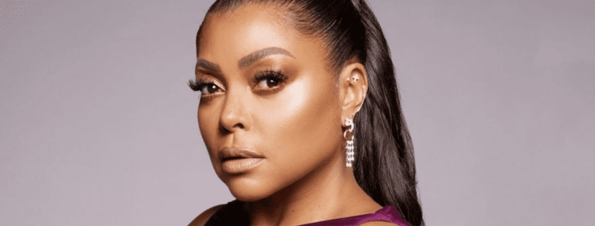 Woman with earrings and sleek hairstyle.